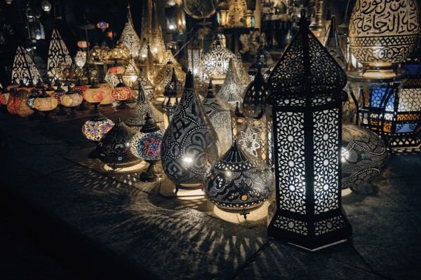 Glowing arabic lamps for sale in front of egyptian souvenir shop. Traditional middle eastern lanterns. Khan El Khalili market, Cairo, Egypt, Africa