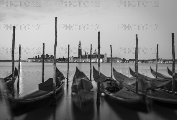 Moving Gondolas on Venice waterfront, San Giorgio Maggiore on the background