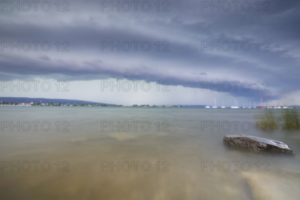 Gloomy mood with boats on the horizon under a cloudy, grey sky with a shelf cloud, Allensbach, Untersee, Lake Constance, Constance District, Baden-Württemberg, Germany, Europe