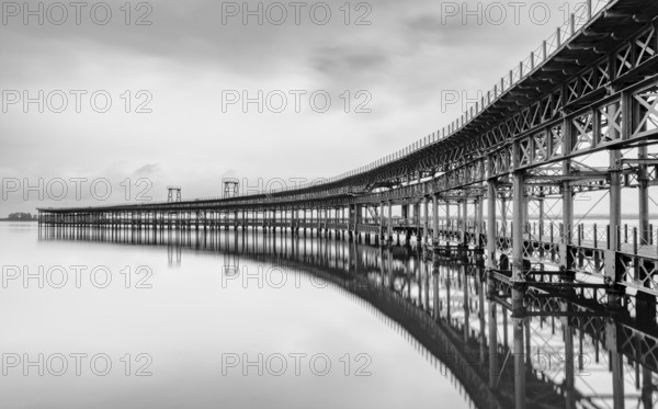 A black and white long exposure view of the historic Rio Tinto pier in Huelva