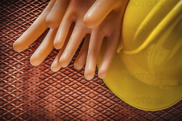 Insulating gloves Construction helmet on dielectric rubber mat