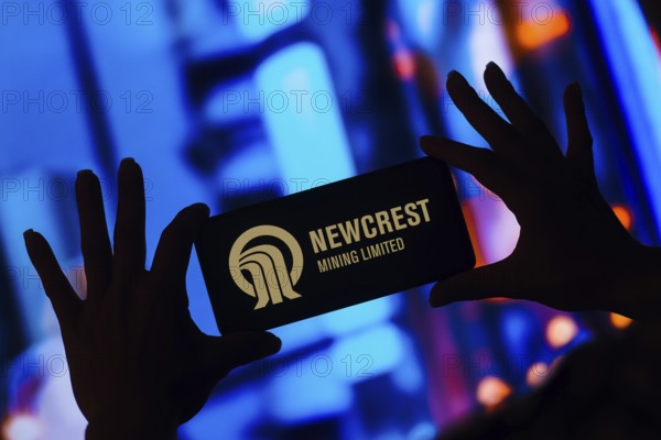 In this photo illustration, the Newcrest Mining Limited logo is displayed on a smartphone screen