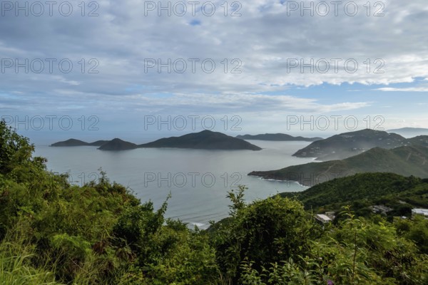 Tortola, in the British Virgin Islands, captivates with lush hills, white sand beaches, and vibrant homes, showcasing Caribbean charm amid stunning seascapes