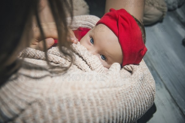 Loving Mother Cuddling Sleeping Newborn Baby daughter Over Shoulder