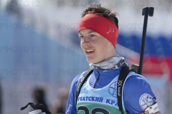 Portrait of sportsman biathlete Sporshev Nikita at finish after rifle shooting and skiing. Junior biathlon competitions East of Cup. Petropavlovsk-Kamchatsky City, Kamchatka, Russia, April 14, 2019, Europe