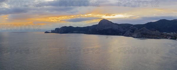 Sunset on the Black Sea coast of Crimea. View from the top of Cape Alchak to the west, towards Novyy Svet