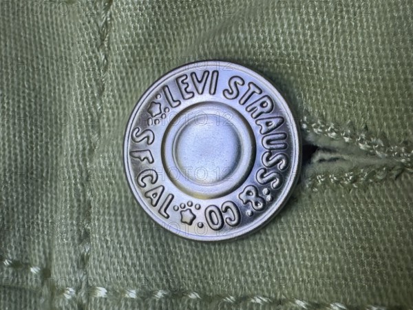 Calgary, Alberta, Canada. Jul 07, 2024. Close-up of a metal button branded with