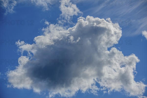 Large, dramatic cloud against a blue sky, creating both light and shadow, Mitterteich, Upper Palatinate, Bavaria, Germany, Europe