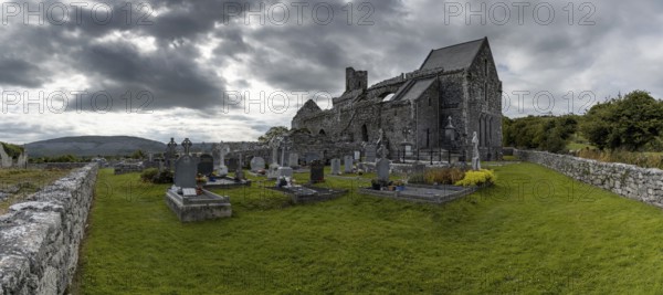 Ballyvaughan, Ireland, 28 July, 2022: panorama view of the historic 13th-century Corcomroe Abbey and cemetery in County Clare, Europe
