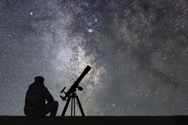Man with astronomy telescope looking at the stars. Man telescope and starry sky. Night sky. Milky way galaxy