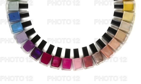 Bottles with nail polish arranged in a semicircle. Isolate on white background