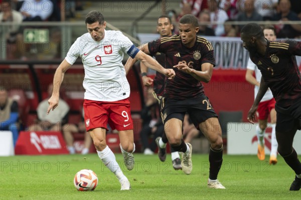 WARSAW, POLAND - JUNE 16, 2023: Friendly football match Poland vs Germany 1:0. In action Robert Lewandowski (L) and Malick Thiaw (R).