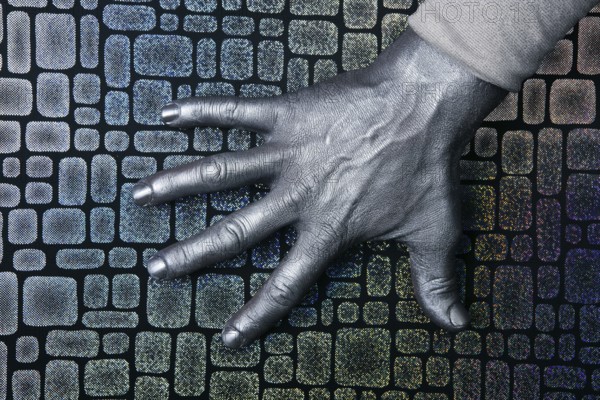 Male futuristic man silver hand over textured steel background