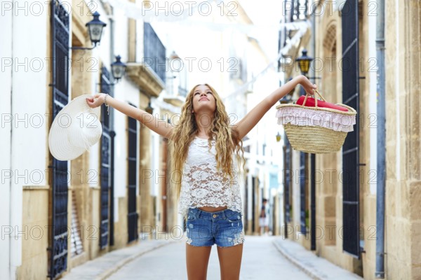 Blond tourist girl in mediterranean old town of Spain