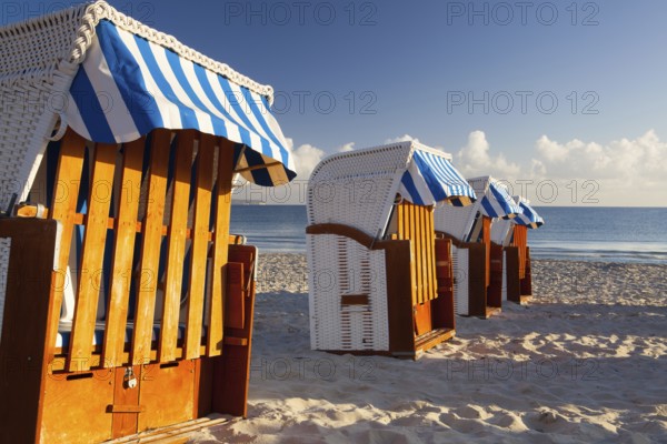 Sandy beach and traditional wooden beach chairs on Rugen island, Northern Germany, on the coast of Baltic Sea