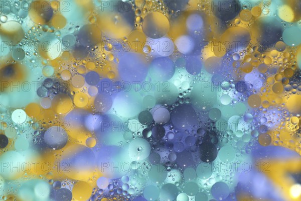 Oil on water over colourful background, pattern