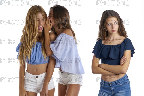 Teen best friends bullying a girl sad apart out of the game on white background