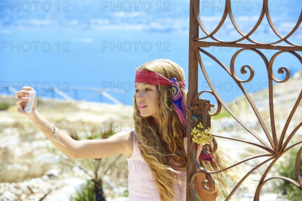 Blond girl selfie photo in mediterranean sea gate at Spain