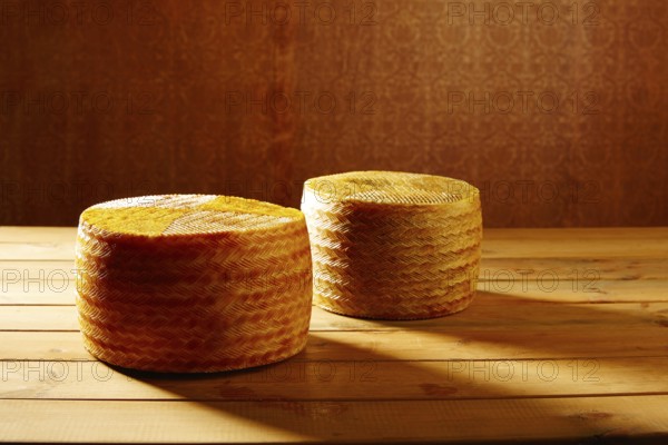 Manchego cheese from Spain in wooden table two whole pieces