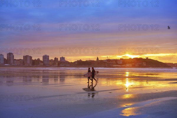 Gijon sunset San Lorenzo beach with surfers in Asturias of spain
