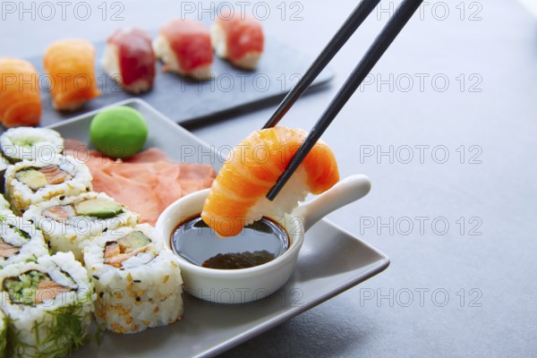 Sushi Maki and Niguiri with soy sauce and wasabi with California Roll