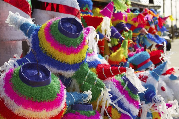 Mexican party pinatas decorated with fringed tissue colorful paper