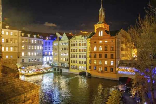 View from the Charles Bridge on the medieval houses of Prague, painted in different colors and the water of the Vltava river (small Bay)