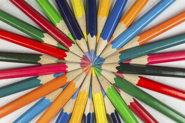 Abstract composition of complementary cirkel with color pencils against a white background