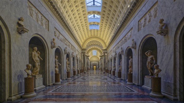 Grand museum corridor lined with marble statues and ornate arches, Chiaramonti museum, Rome, Lazio, Italy, Europe