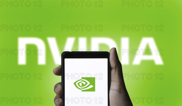 Nvidia logo on smartphone screen with AI in the background. Nvidia Corporation is an American multinational corporation and technology company.