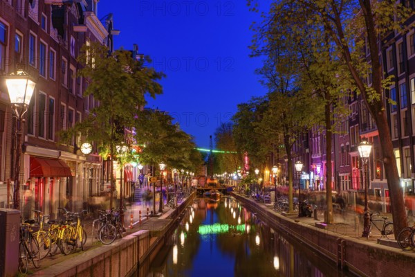Night view of De Wallen, the famous red-light district with window prostitution in Amsterdam, Netherlands