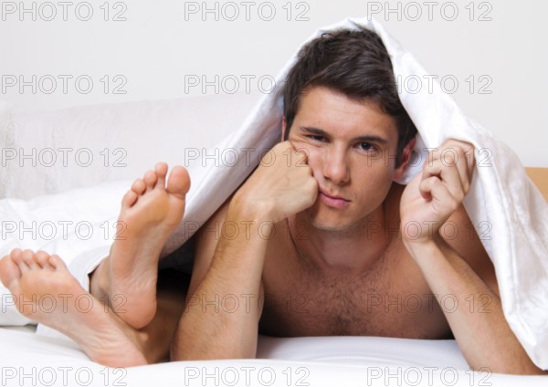 A young couple in bed having problems and crisis. Divorce and separation, A young couple in bed having problems and crisis. Divorce and separation. Austria