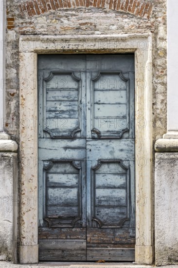 An old wooden blue door at a house in Italy