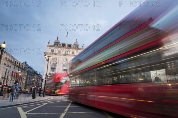 London, England, March 19, 2018: Night scene from the famous London Piccadilly circus square at the centre of London with cars and buses leaving colorful light traces