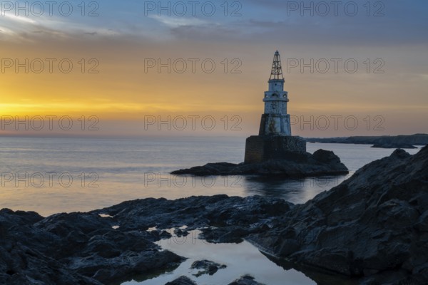 The Athopol Lighthouse on the Black Sea coast of Bulgaria with tidal pools in the foreground at sunrise