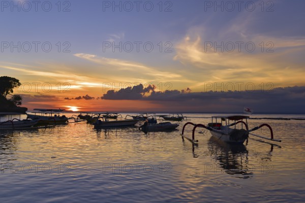 Sunset at Mushroom Beach with boats on the sea, Lembongan, Bali, Indonesia, Asia