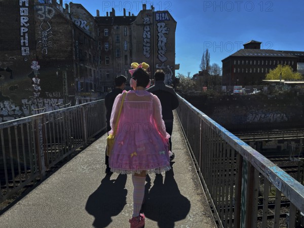 Germany, Berlin, 04.04.2025, girl / woman in pink dress, with bee antennae, Schönfliesser makeshift bridge, Europe