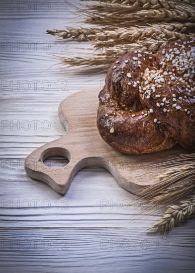 Chopping board wheat rye ears bread stick on wooden background food and drink concept