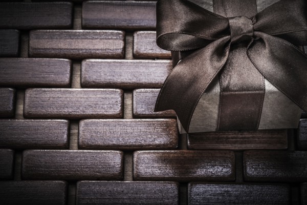 Gift box on wooden wicker place mat holidays concept