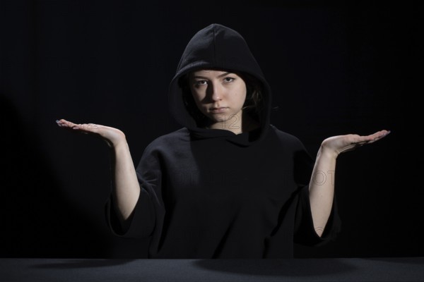 A young woman is waiting for the development of the situation in difficult conditions on the labor market