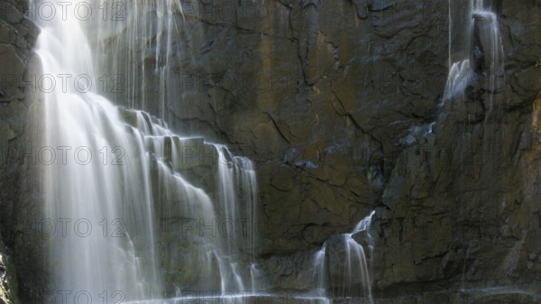 Detail of a waterfall in long exposure and rocky background, Australia, Oceania