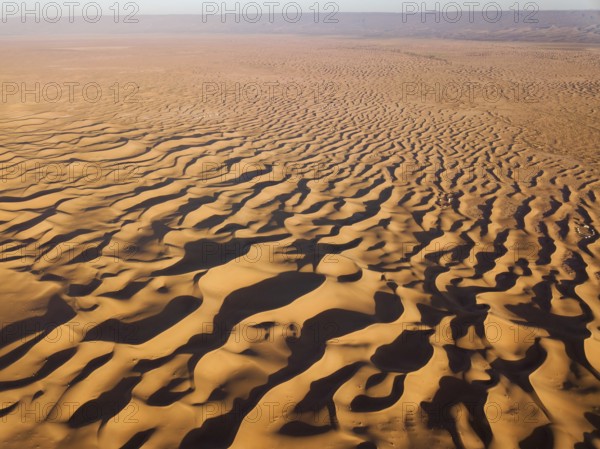 Aerial top high view landscape in Sahara desert at sunrise