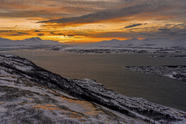 Winter view from Mount Storsteinen to the southern tip of Tromso at sunset, Troms, Norway, Europe