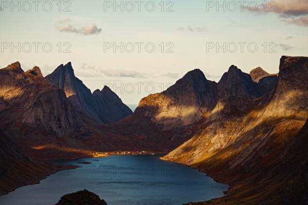 Mountain peaks casting shadows over a tranquil lake at sunset, mountains, rocks, road, sea, ocean, water, nature, Reine vilage, Reinebringen, Lofoten Islands, Norway, Norge, Europe