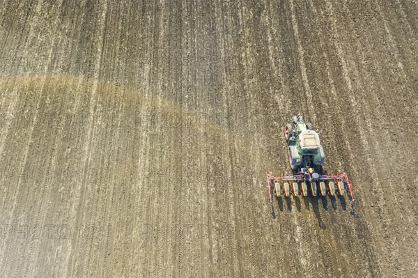 Farmer seeding crops at field. Seeding Aerial View