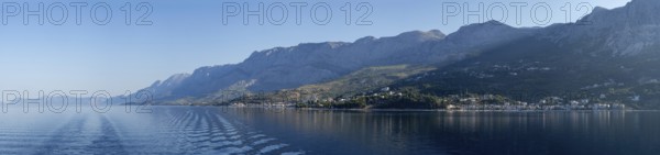Mountain range by the sea in the morning light, panoramic shot, Makarska Riviera, near Makarska, Dalmatia, Croatia, Europe