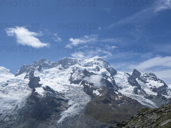 View towards one of the peaks of Switzerland above 4000m: Breithorn close to Zermmat, Valais. Situation on a beautiful sunny summer day