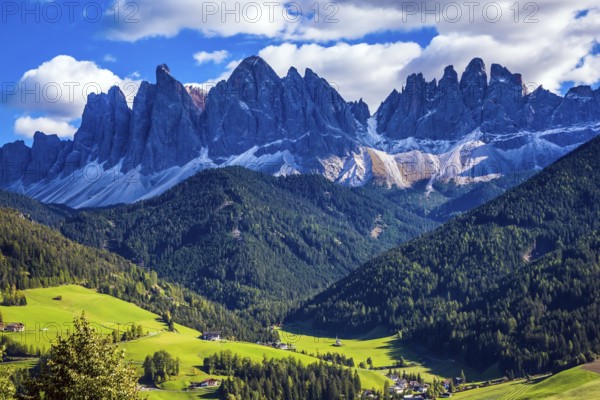 Odle mountain peaks surround the green alpine meadows of the valley. Dolomites, Val de Funes valley. Lovely sunny day in Nature Park Puez-Odle