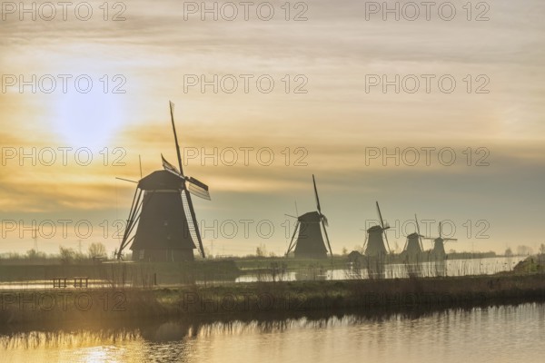 Dutch Windmill sunrise landscape at Kinderdijk Village Netherlands
