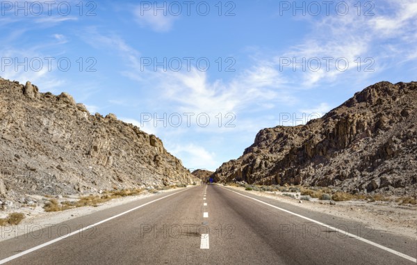 Speed highway through Egyptian mountains in desert